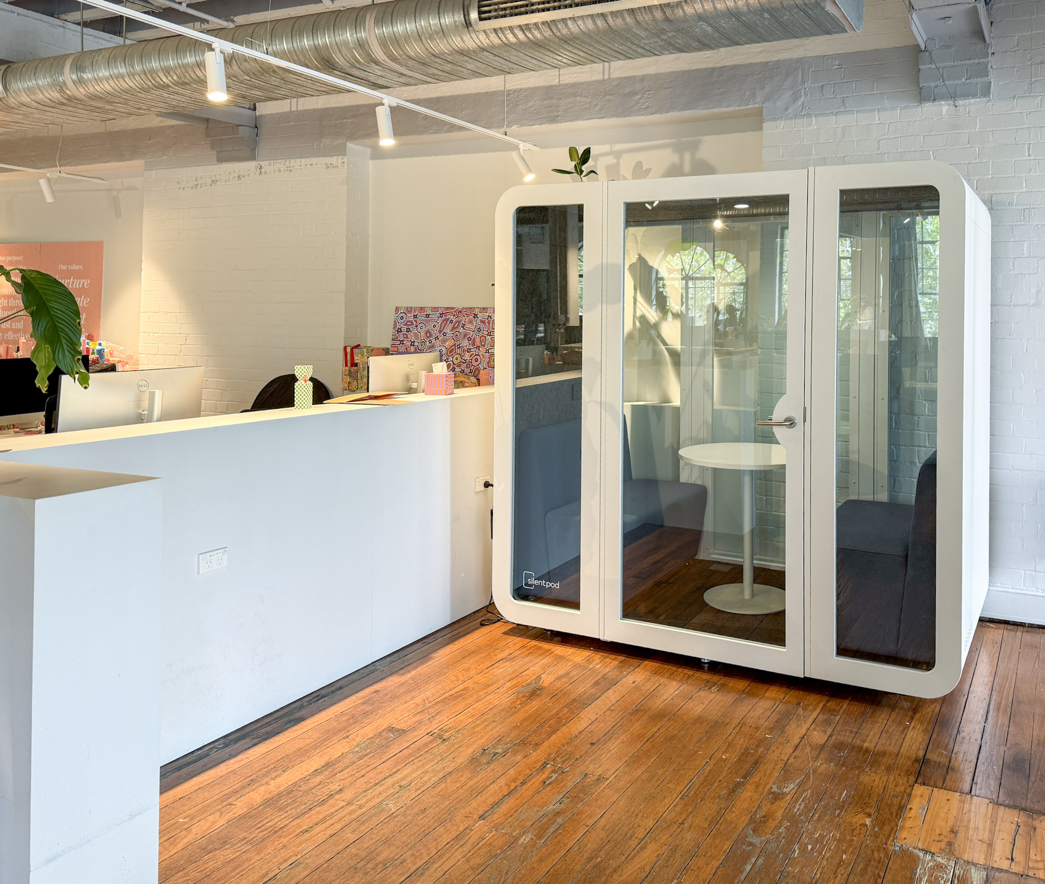 Interior view of a modern office with a newly installed Silent Pod Collab Pod, enhancing workspace flexibility in a heritage building in Surry Hills.