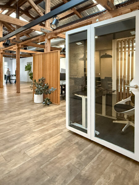 Silent Pod Connect installed in a heritage office space at Tracksuit’s Redfern HQ, surrounded by timber beams and open-plan desks.