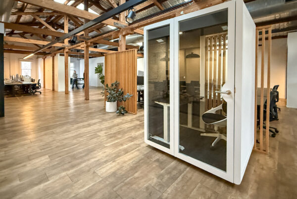 Silent Pod Connect installed in a heritage office space at Tracksuit’s Redfern HQ, surrounded by timber beams and open-plan desks.
