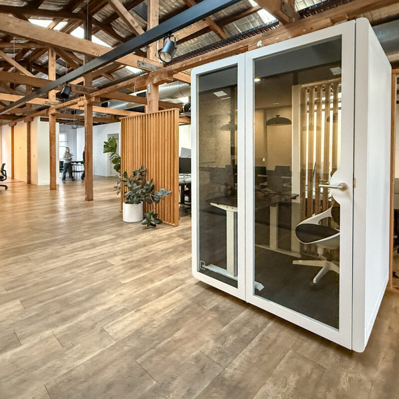 Silent Pod Connect installed in a heritage office space at Tracksuit’s Redfern HQ, surrounded by timber beams and open-plan desks.