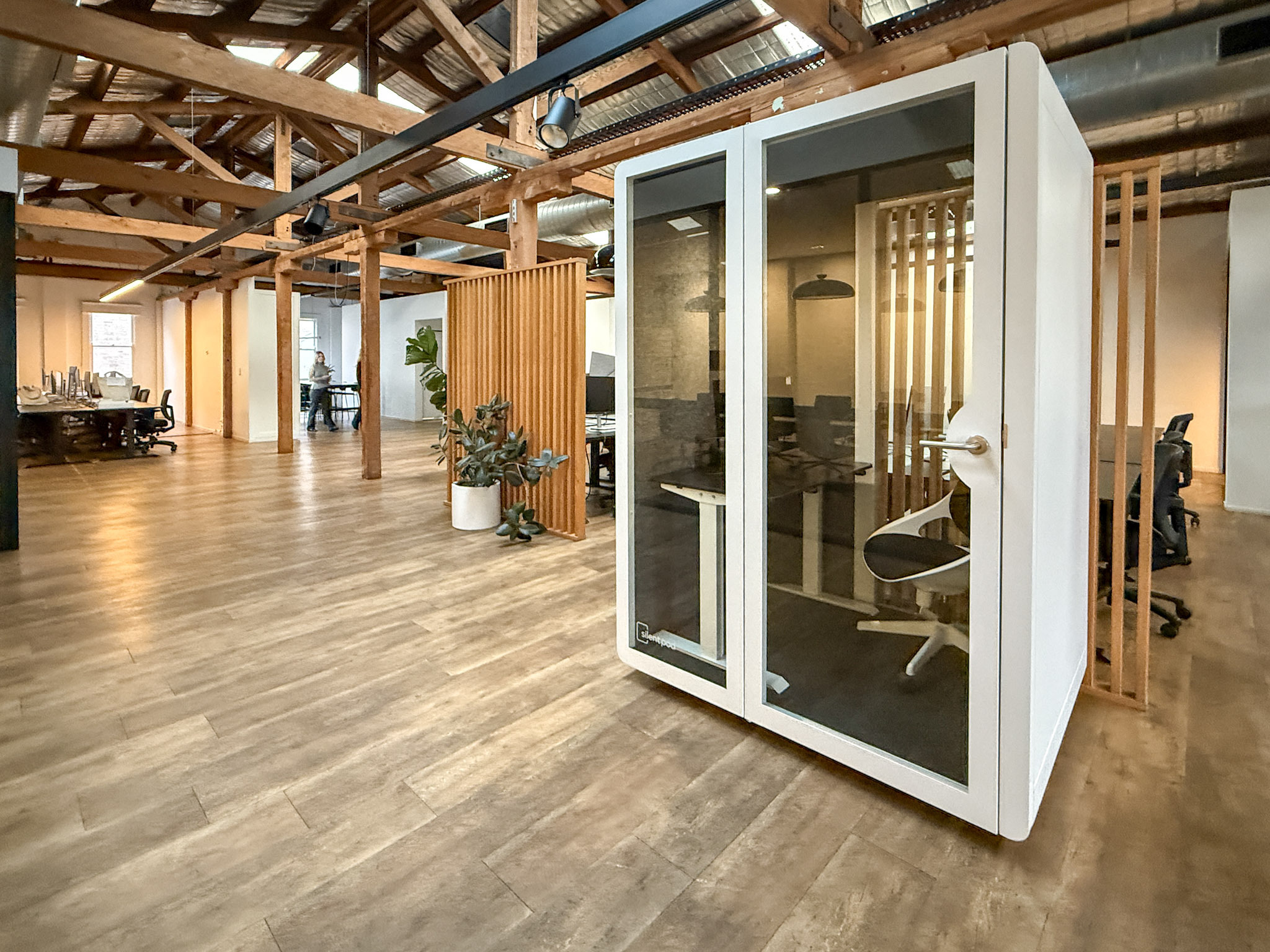 Silent Pod Connect installed in a heritage office space at Tracksuit’s Redfern HQ, surrounded by timber beams and open-plan desks.