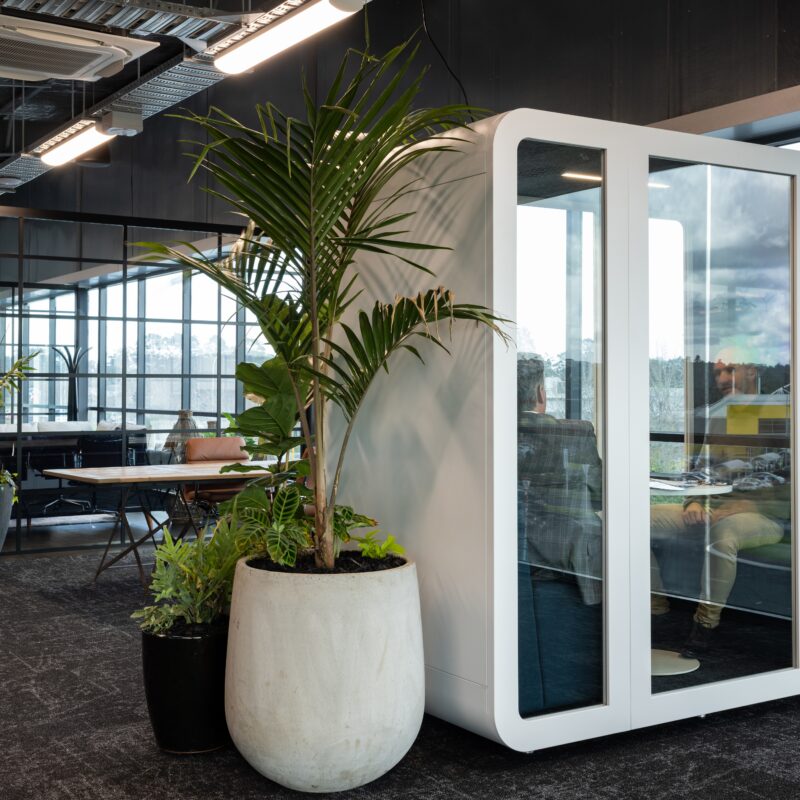Two people having a private discussion inside of a silent pod Collab Pod (Privacy office pod)